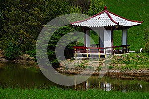 Small chinese pavilion at the garden pond in Arboretum Mlynany, Slovakia