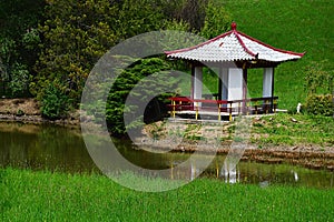 Small chinese pavilion at the garden pond in Arboretum Mlynany, Slovakia