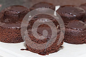Small chocolate cakes with dripping chocolate icing on top