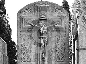Small christ on the cross on the tombstone