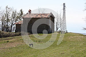 Small church abandoned, in disuse, on the Apuan Alps of the Tuscan Apennines in a clearing on a sunny spring day