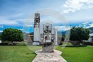 Small church with dice trees and beautiful grass in the atrium in the middle of the mountains in mexico