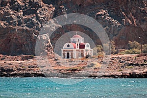 Small church on a rocky seashore in Greece