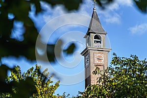 Small church steeple with clock and time dial in a small Dutch village