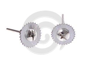 Small circular saw blade with a long screw and two small screws screwed onto the thread, isolated white