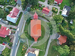 small city, aerial view on main road, buildings and red brick church