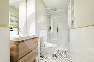 Small cloakroom with oval bevelled mirror, red tiles and small white porcelain sink photo