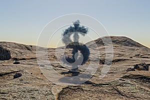 small cloud dollar symbol in large desert environment with sand dunes, hills and rocks laying arround business profit concept 3D