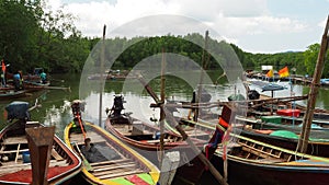 Small coastal fishing boats are docked at the pier.