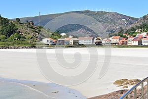 Small coastal village with beach and mountain. Playa de San Pedro Playa de O Pindo. Carnota, Spain. photo
