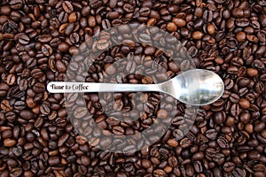 Background with many coffee beans and metal spoon photo