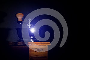 Small coffee grinder black background purple light