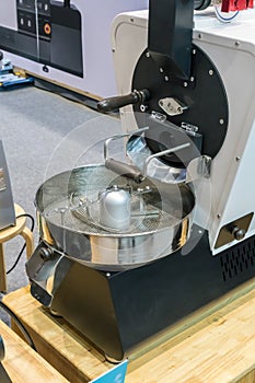 Small coffee roaster machine with automatic system on table.