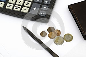 Small coins wallet calculator and fountain pen on sheets of white paper on the table concept business budget economy