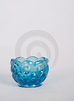 Small blue glass bowl on white photo