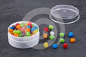 Small colored candies in the plastic container