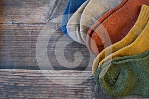 Small colorful baby socks on wooden background