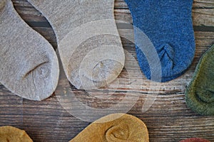 Small colorful baby socks on wooden background