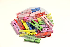 Small and colorful clothespins. On a white background