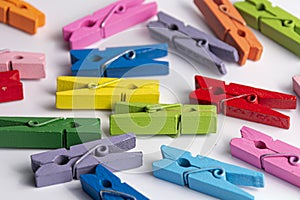Small, colorful clothespins. On a white background