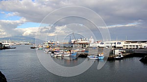 Small colorful fishing boats moored at the pier of the fishing port, Ponta Delgada, Sao Miguel, Azores, Portugal