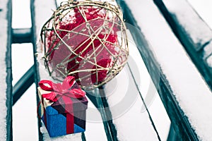 Small colorful gift box on a bench