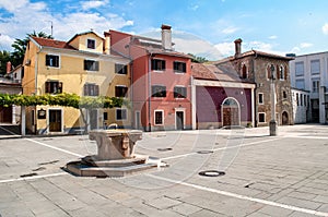 Small colorful houses and a cobbled square in the port city of Koper in Slovenia.