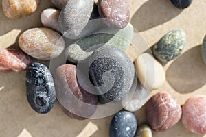 Small colorful pebbles background, simplicity, daylight, stones, white, green, grey, red, orange,