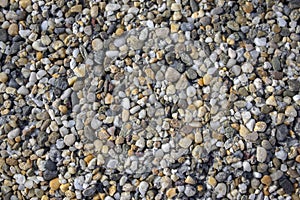 Small colorful pebbles background, tiny beach stones, various colors