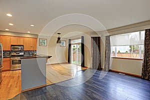 Small compact kitchen room with hardwood floor.