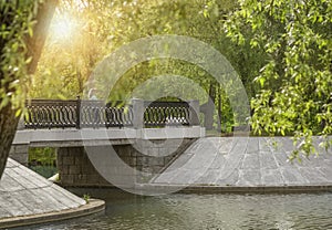 A small concrete bridge over the river in the city park