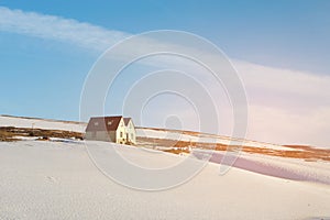 Small cottage over mountain slope with snow covered