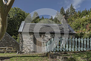 Small cottage with a blue picket fence