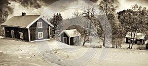 Small cottages in old rural winter landscape
