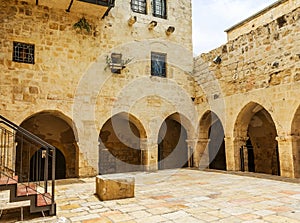 A small courtyard with arches in the walls of ancient Jerusalem