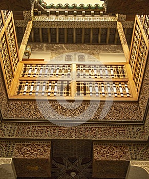 Small courtyard serving the student dormitories with wood carving in madrasa Ben Youssef Madrasa in Marrakesh, Morocco photo