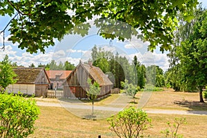 Small cozy houses. Wooden ancient buildings. Summer village and vacation. Farm bio products.