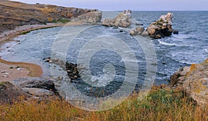 A small cozy sandy cove among the coastal rocks in the eastern Crimea, Kazantip, the Black Sea