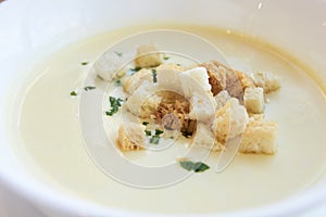 Small crackers. Delicious cheese soup. White dishes