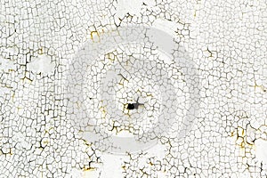 Small cracks on the old white wall