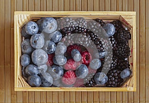 Small crate wiA small crate of berries - raspberries, blackberries and th flat nectarines, cherries, blueberries and blackberries.