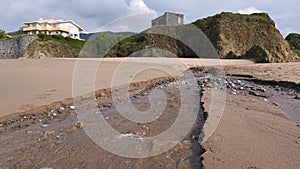 Small creek with water going down on the beach