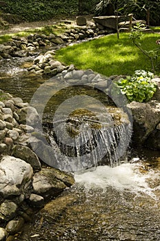 A small creek with a waterfall