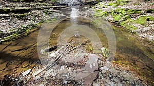 A small creek and waterfalls in autumn forest