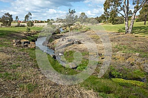 A small creek/waterway in a large public park. Australian nature landscape. Hoppers Crossing Drain, Melbourne, VIC Australia