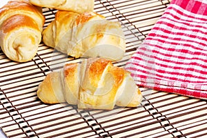 Small croissants  with checkered napkin in background