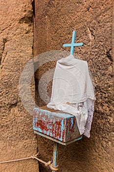 Small cross near Bet Medhane Alem, rock-cut church in Lalibela, Ethiop photo