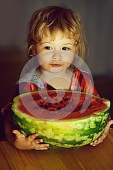Small boy eating red watermelon