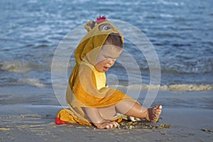 Small cute baby playing on the beach.Happy child on vacation with beautiful sea and sand on the beach.