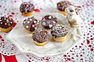 Small cupcakes with chocolate ganache and sprinkles photo